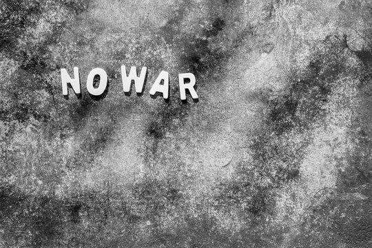 Wooden letters "NO WAR" on the cement background