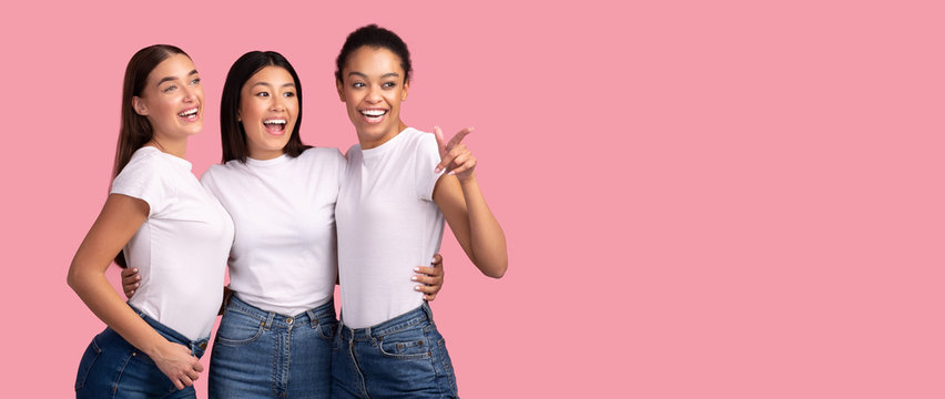 Three Girls Pointing Finger Looking Aside Standing Over Pink Background