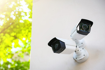 Outdoor CCTV monitoring, security cameras with sunlight flare.