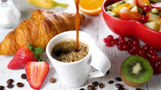 healthy breakfast with coffee cup, fruit and croissant