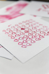 Greeting card for Valentine's Day. Pink hearts painted with watercolor paints.