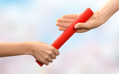 Close-up of relay baton being passed