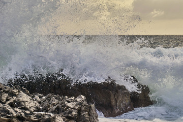 Strong waves in the sea hitting the rocks of the coast