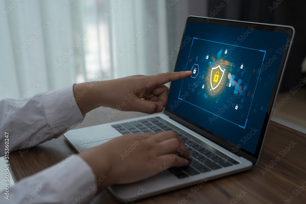 Poster person using a laptop computer with data protection, cyber security, information safety and encrypti