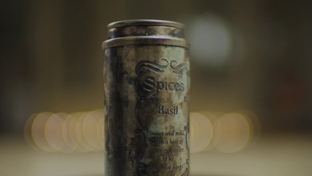 Antique spices jars rotating in slow motion. Basil spices bottle rolling in 360 degree. 