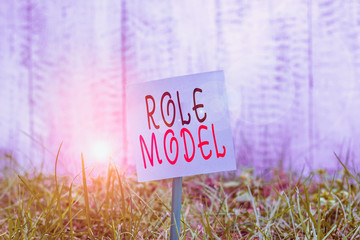 Text sign showing Role Model. Business photo showcasing a demonstrating looked to by others as an...