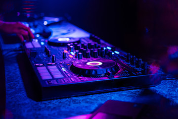 DJ mixer controller at a party in a nightclub