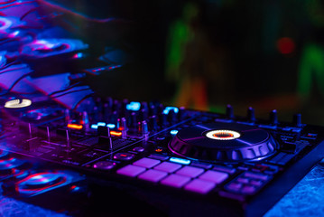 Obraz na płótnie Canvas music mixer DJ controller in booth at nightclub