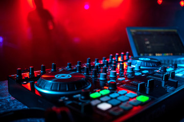 professional music equipment DJ in a booth in a nightclub