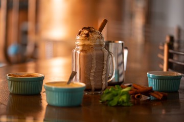 A glass jar of coffee shake with cinnamon