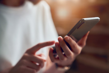 Close-up of woman holding a smartphone and using online social on lifestyle. Technology for communication concept.