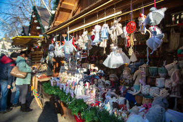 Fototapeta premium Christmas toys hanging in shop on Christmas market