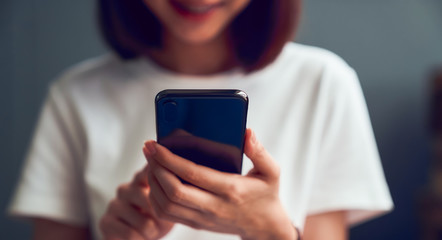 Close-up of woman holding a smartphone and using online social on lifestyle. Technology for communication concept.