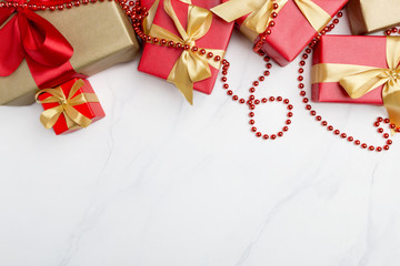 Festive present boxes at white background with golden ribbons