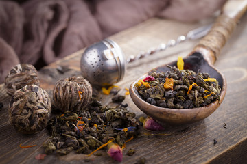 Dry tea leaves on a side background