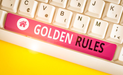 Writing note showing Golden Rules. Business concept for basic principle that should always follow to ensure success White pc keyboard with note paper above the white background