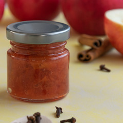 Homemade jam with red apples, cloves and cinamon