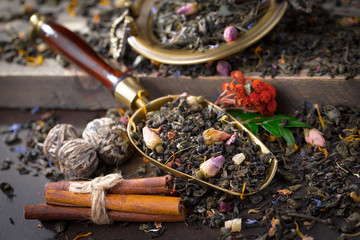 Dry tea leaves on a side background