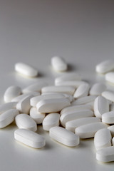 Pills tablets vitamins drugs white close up macro shot