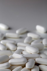 Pills tablets vitamins drugs white close up macro shot
