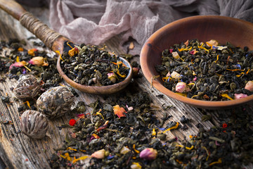 Dry tea leaves on a side background