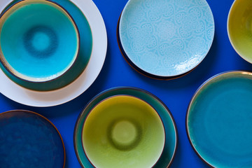 Empty flat and deep plates on a blue background.