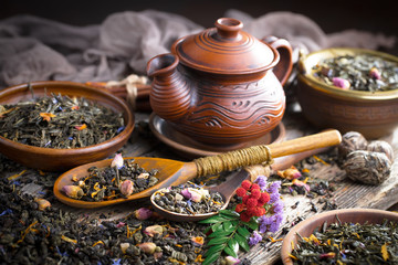 Dry tea leaves on a side background