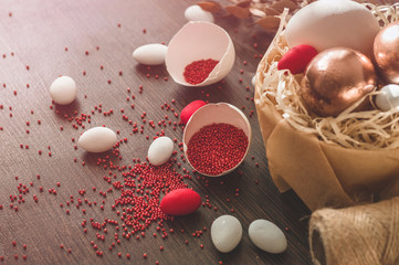 Happy Easter. Flat Lay of Golden Eggs and easter red sprinkle on wooden background