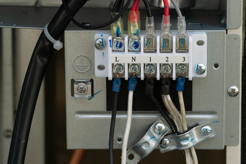Connect the electrical wiring system inside the air conditioner cabinet.