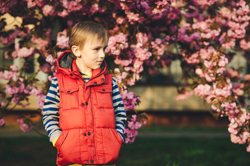 Lovely child in fashion clothes on a walk in springtime. Happy and healthy childhood