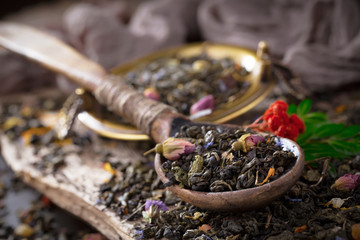 Dry tea leaves on a side background