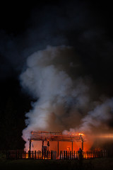 Obraz premium Long shot of a Fire. Unrecognizable Fireman rescue the country house.
