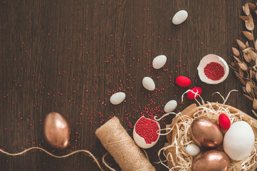 Happy Easter. Flat Lay of Golden Eggs and easter red sprinkle on wooden background