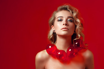 Creative unusual portrait of beauty girl. Christmas balls beads necklace. New year banner with copy space.