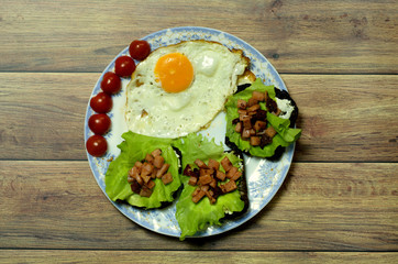 Still life with fried eggs, sandwich and tomatoes