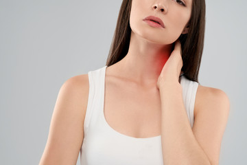 Woman showing pain in neck.