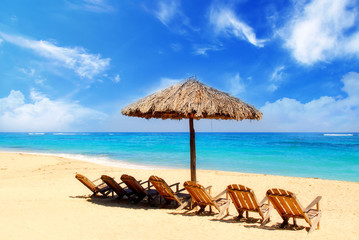 Umbrella and wooden chairs on tropical Caribbean beach, Cuba
