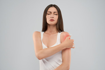 Woman showing pain in shoulder.