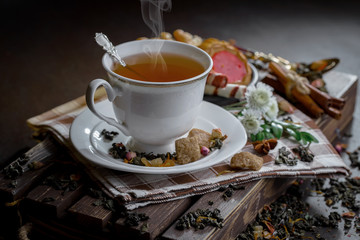 Tea hot drink on old background in composition on the table