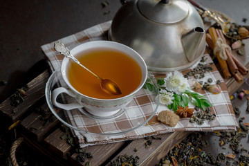 Tea hot drink on old background in composition on the table