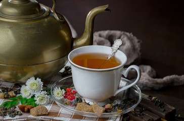 Tea hot drink on old background in composition on the table