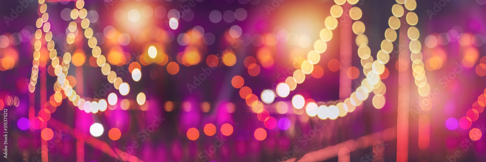 Wall mural blurred bokeh festival night light of city. abstract colourful evening lights background.