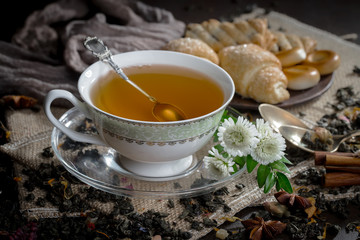 Tea hot drink on old background in composition on the table