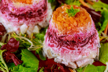Beetroot salad with herring and vegetable layered with mayonnaise.