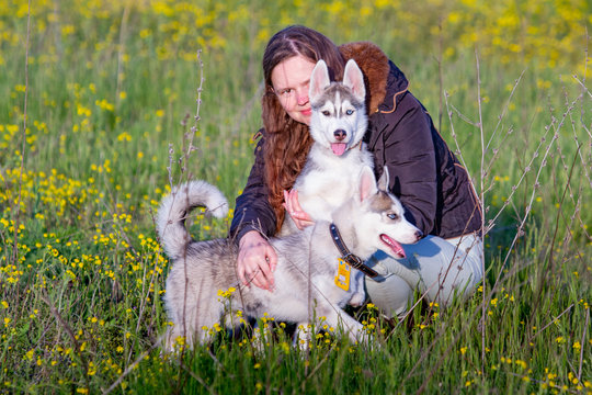 girl in the park their home with a Husky puppy