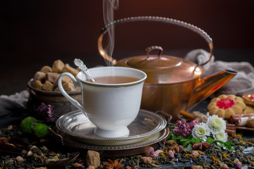 Tea hot drink on old background in composition on the table