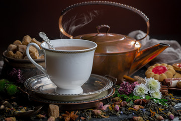 Tea hot drink on old background in composition on the table