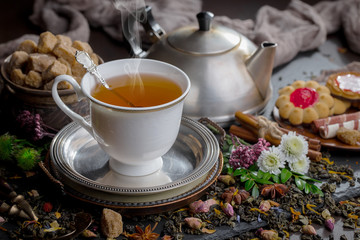 Tea hot drink on old background in composition on the table