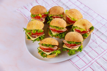 Appetizer small sandwich roll with ham and vegetables.