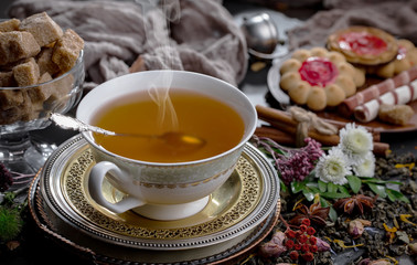 Tea hot drink on old background in composition on the table